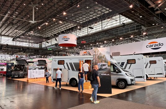 Carado motorhomes at the exhibition stand in the large hall, where visitors explore semi-integrated models