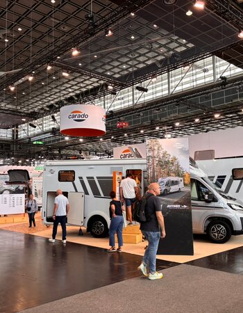 Carado motorhomes at the exhibition stand in the large hall, where visitors explore semi-integrated models