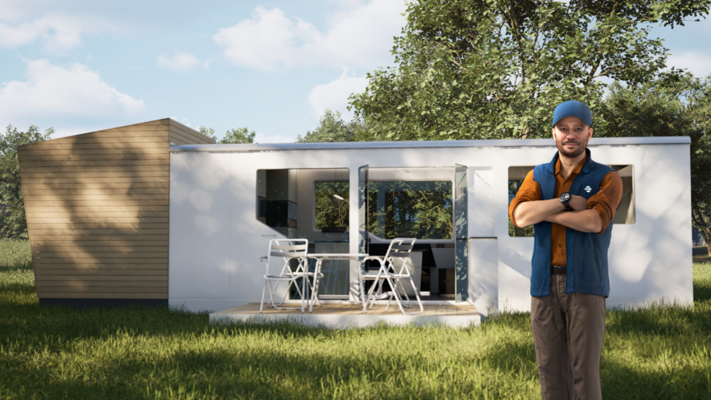 Mann vor modernem Tiny House mit Terrasse, Tisch und Stühlen auf einer Wiese