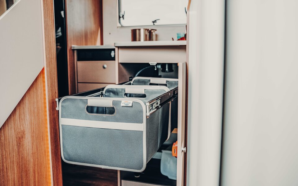 Pull-out fabric storage under the sink in the Carado motorhome