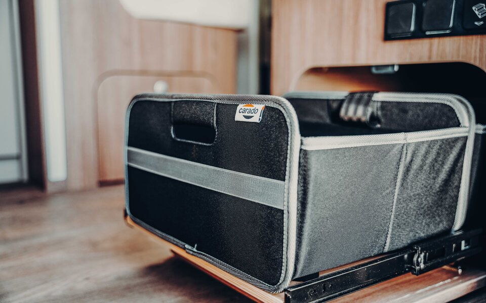 Pull-out fabric basket in the Carado motorhome, close-up of interior storage space