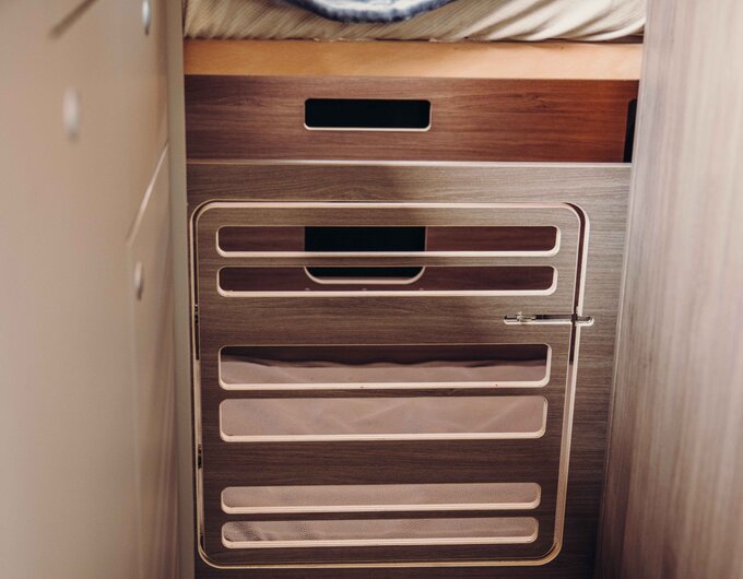 Sleep space in the Carado motorhome with bed, blanket and storage compartment under the bed
