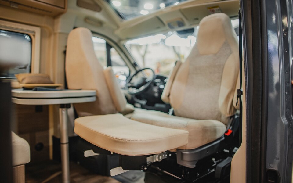 Carado motorhome interior with swivel cab seats and dinette