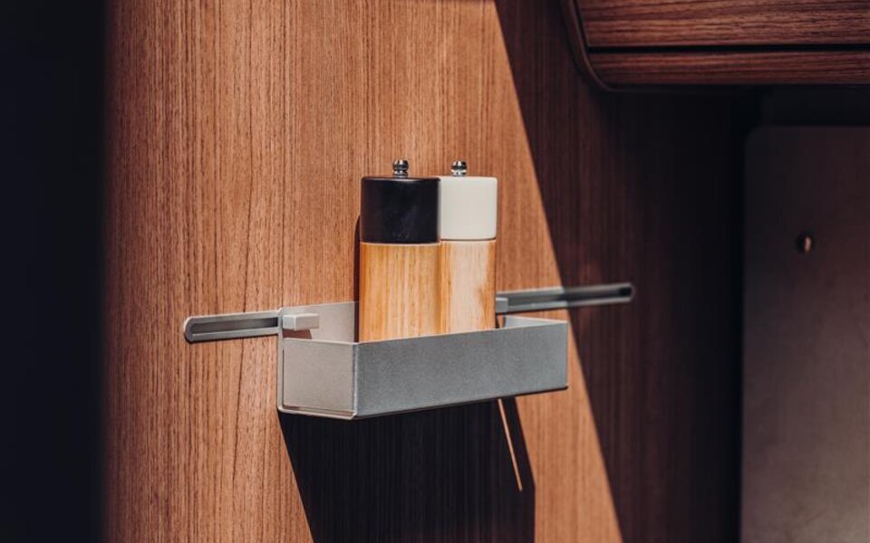 Spice holder on a wooden panel in the Carado motorhome with two mills