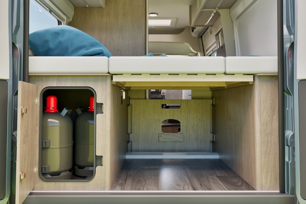 Rear storage space in the Carado motorhome under the bed, with gas locker and storage area