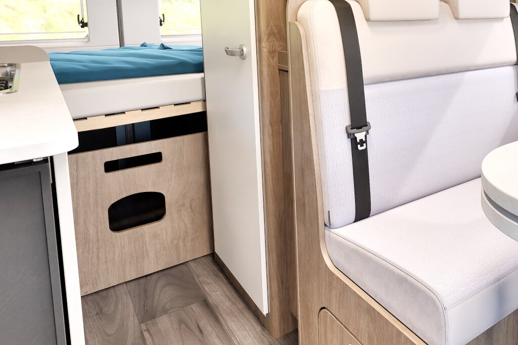 Carado motorhome interior with bench seat, table, rear bed and wood-look storage
