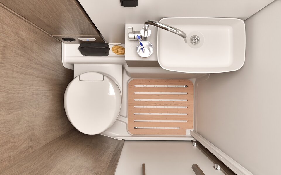 Bathroom in the Carado motorhome with toilet, washbasin and shower tray with wooden slatted floor