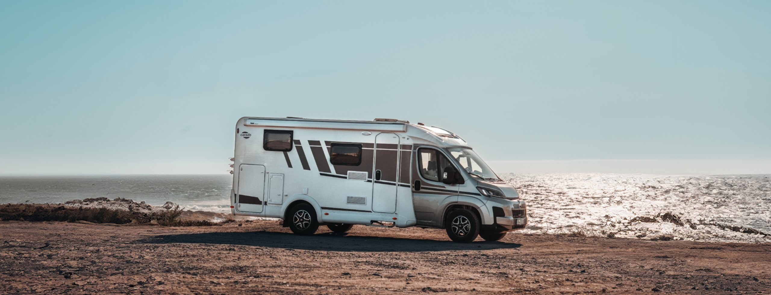 Carado motorhome in side view on a coastal site by the sea