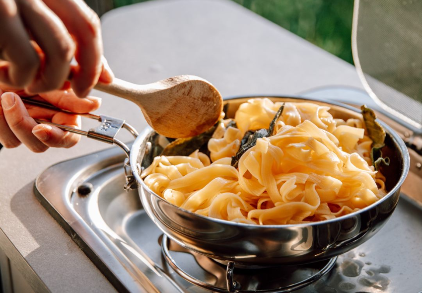Preparing tagliatelle in the motorhome kitchen of an Etrusco Alcove Motorhome Fiat – Enjoyable cooking on camping trips.