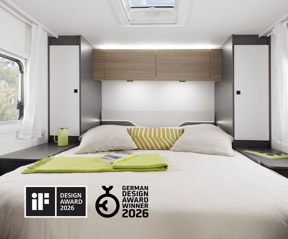 Sleeping area of a modern Fiat motorhome with a cozy double bed, surrounded by storage cabinets – ideal for camping adventures.