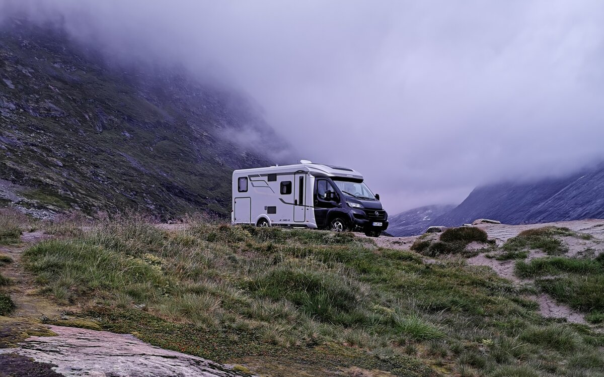 HYMER Exsis-t 580 in a stony mountain landscape in the clouds