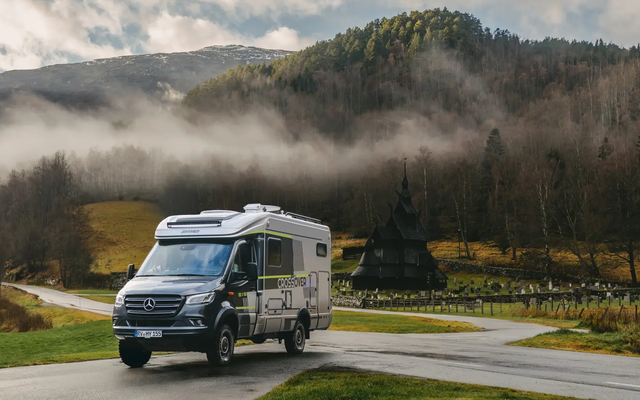 View of the HYMER ML-T CrossOver, the Borgund Stave Church is visible in the background, forests with tall trees behind the church