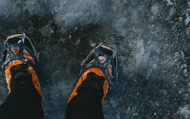 View of snowshoes, person standing on ice