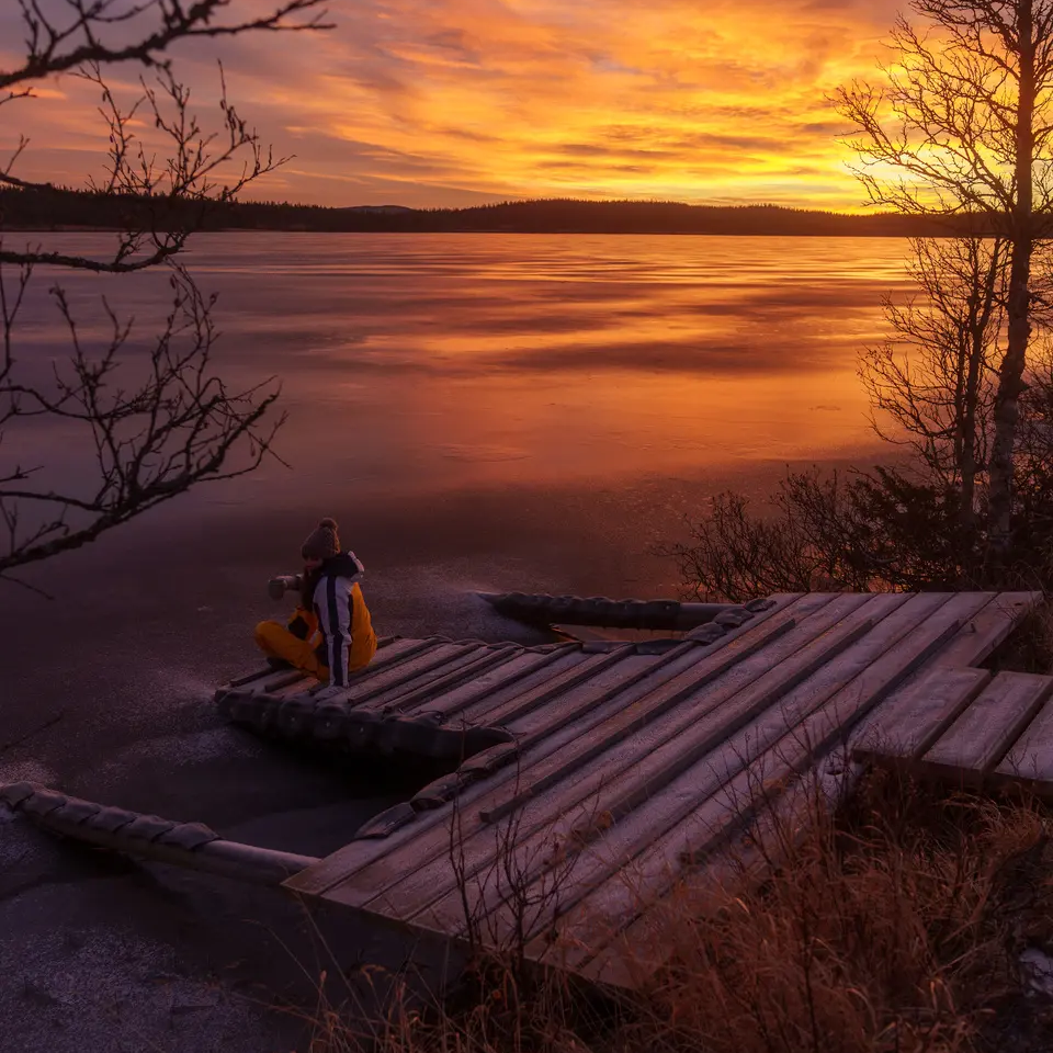 View of a jetty at the lake, beautiful sunset in the background