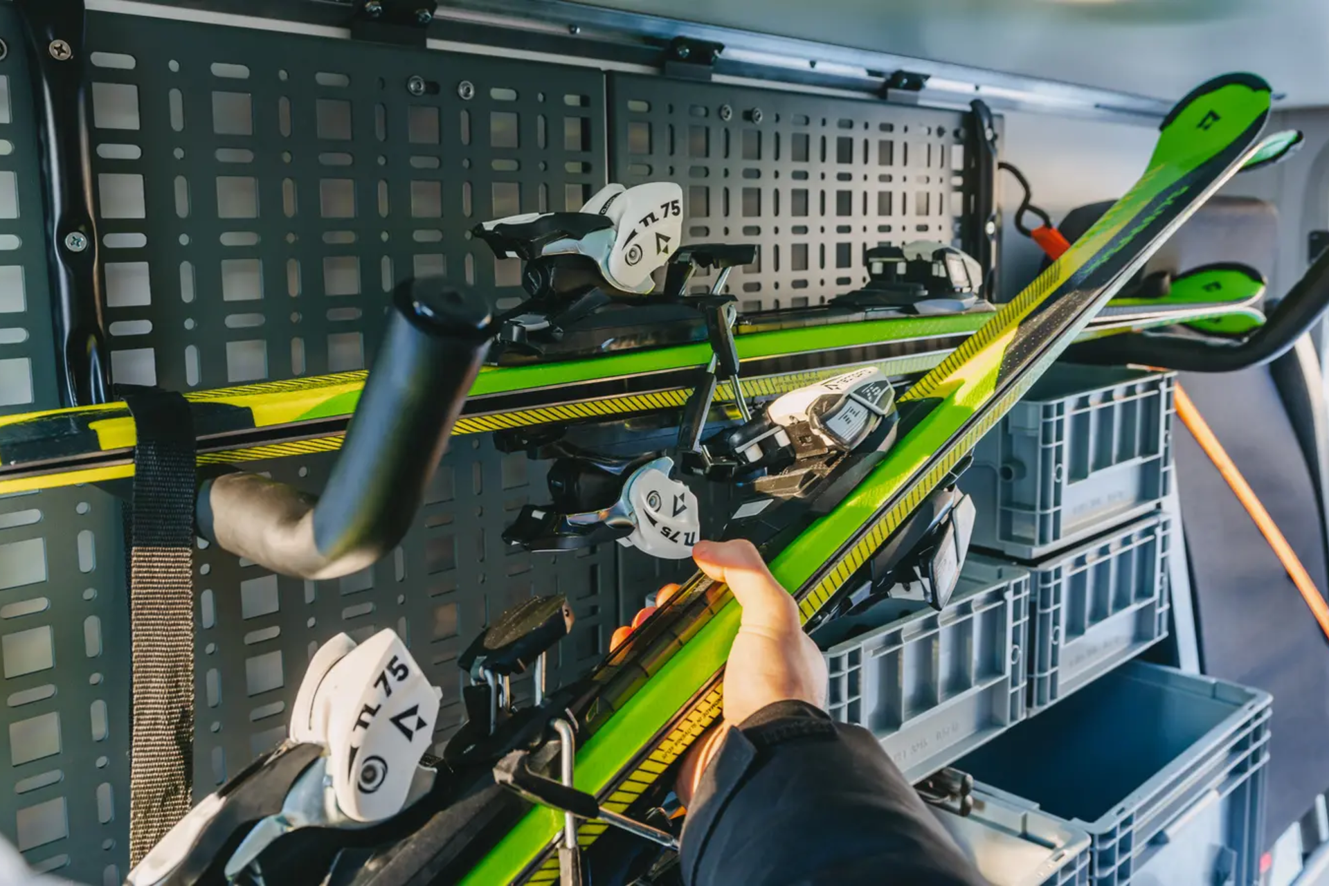 2 pairs of skis stored in the rear garage of a motorhome