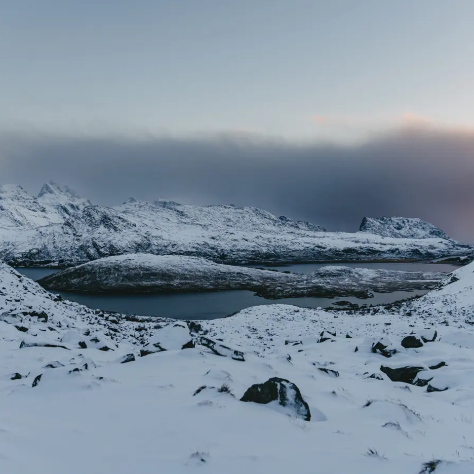 Snow-covered mountains, fjord in the background