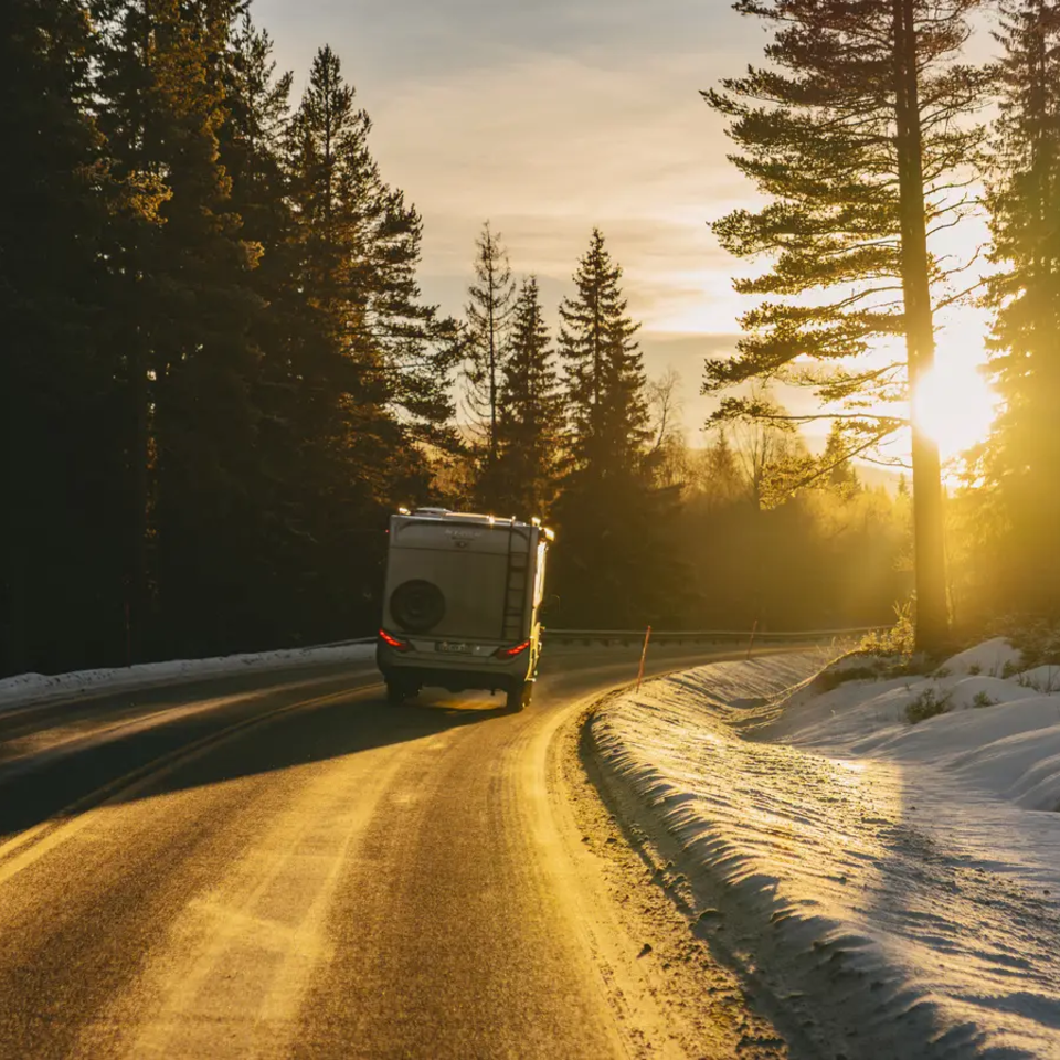 HYMER ML-T 570 CrossOver driving in a forest towards the sunset